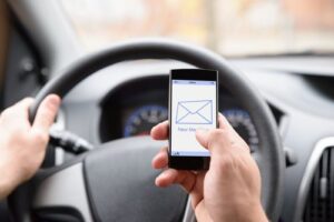 A new law makes it illegal for drivers to use portable electronic devices while in motion.
