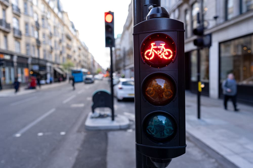 Red bicycle traffic light, highlighting cycling regulations and road safety measures.