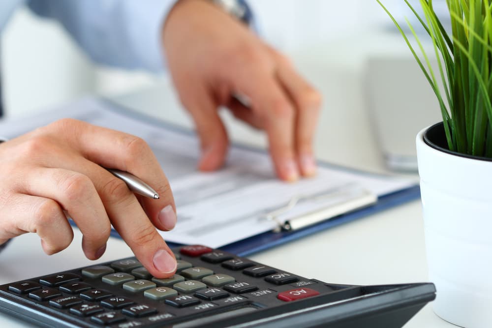 A close-up view of a lawyer calculating pain and suffering damages following an accident.
