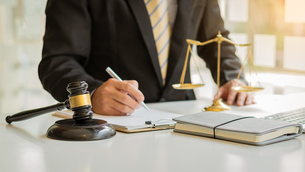 Personal injury lawyer signing document Personal injury lawyer signing document