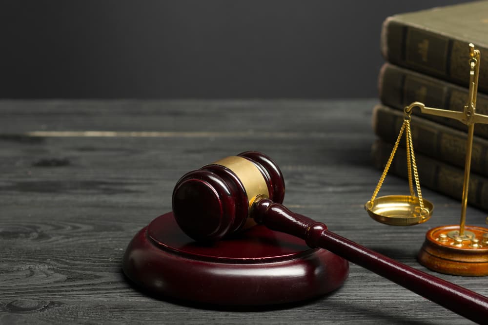 Judge’s gavel and scales of justice on desk representing legal court case and law. Judge’s gavel and scales of justice on desk representing legal court case and law.