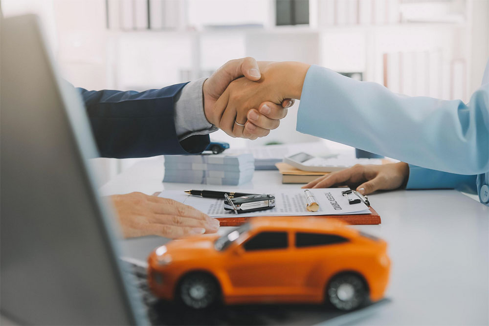 Car accident settlement agreement handshake between lawyer and client in office. Car accident settlement agreement handshake between lawyer and client in office.