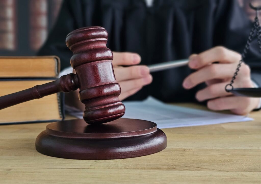Judge’s gavel on desk in courtroom representing legal proceedings and civil lawsuit decisions. Judge’s gavel on desk in courtroom representing legal proceedings and civil lawsuit decisions.