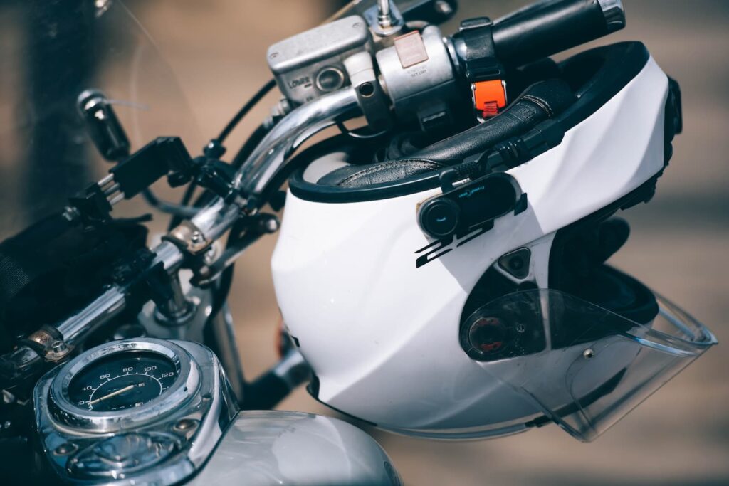 New York Motorcycle Helmet Law and Injury Claims Explained New York motorcycle helmet law DOT-approved helmet on motorcycle handlebar injury claim legal concept